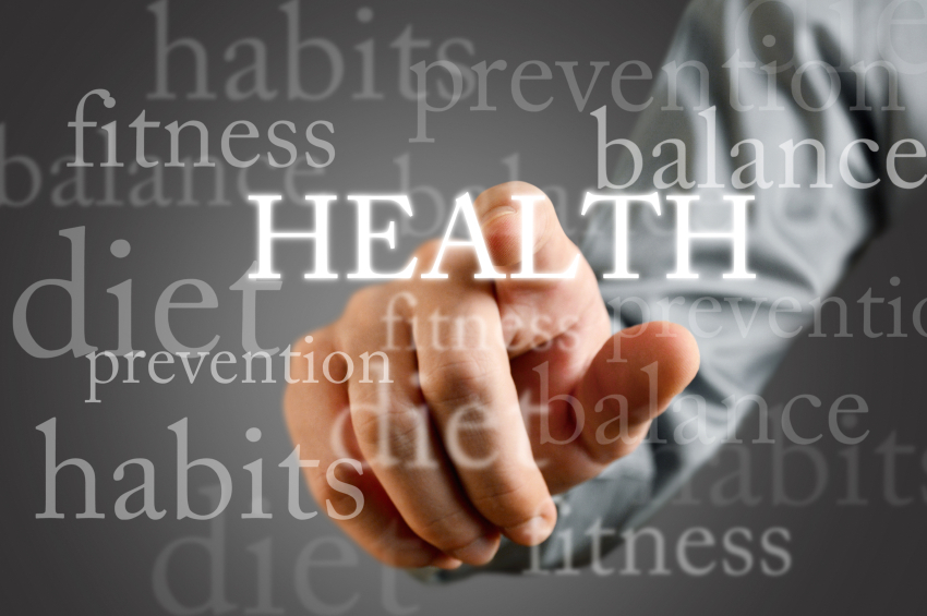 hand on a touch screen pointing to the word "health"
