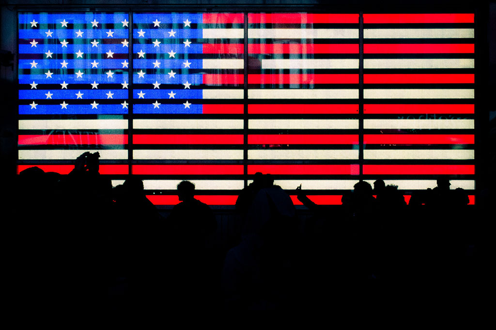 The concept of the American Dream has been challenged: A digital version of the United States flag on a large screen
