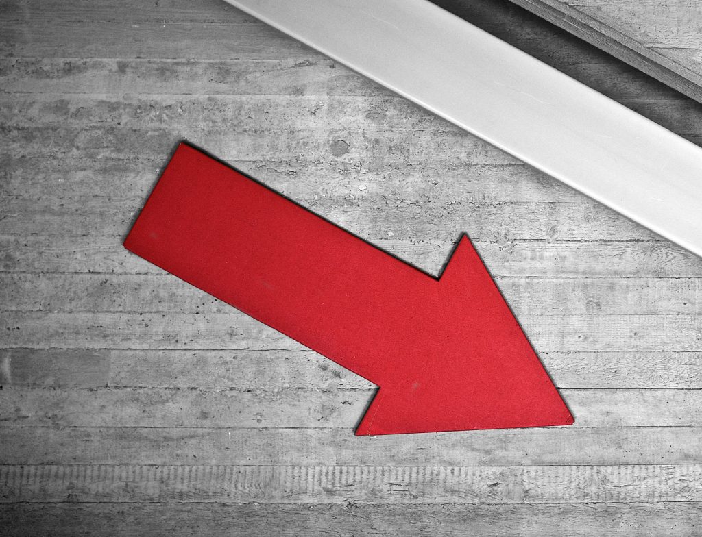 Red arrow on a wall pointing down