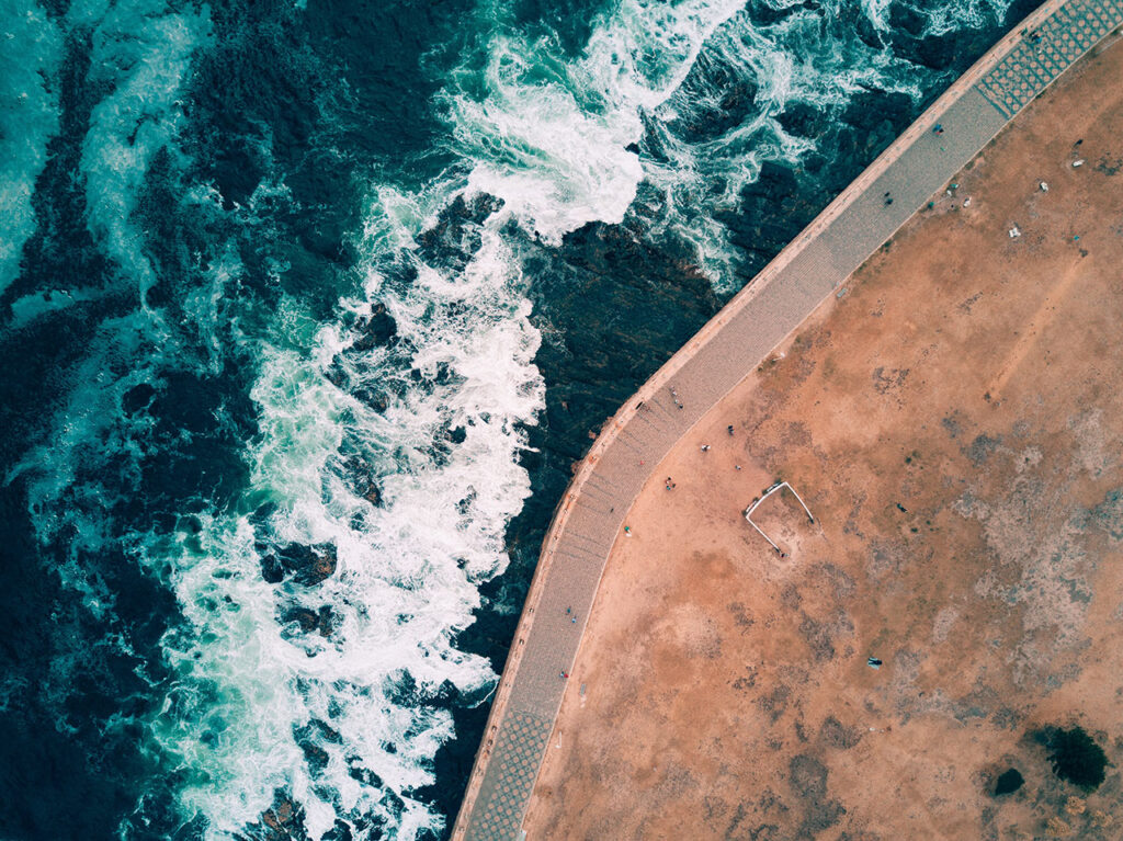 A road along the beach turns to hug the shoreline